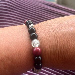 Maroon and black glass with crackle clear glass beads. Hand crafted with love.